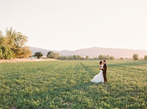 Couple in an open field at golden hour